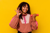 Young mixed race sport woman isolated on yellow background