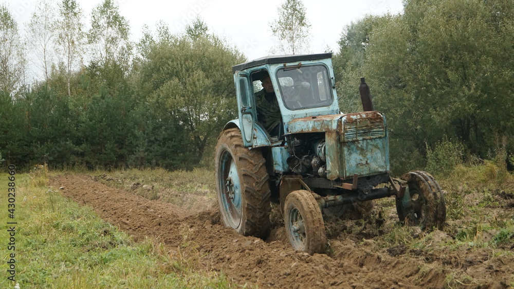 tractor ploughs arable land, an agricultural concept tractor ploughs arable land, an agricultural concept