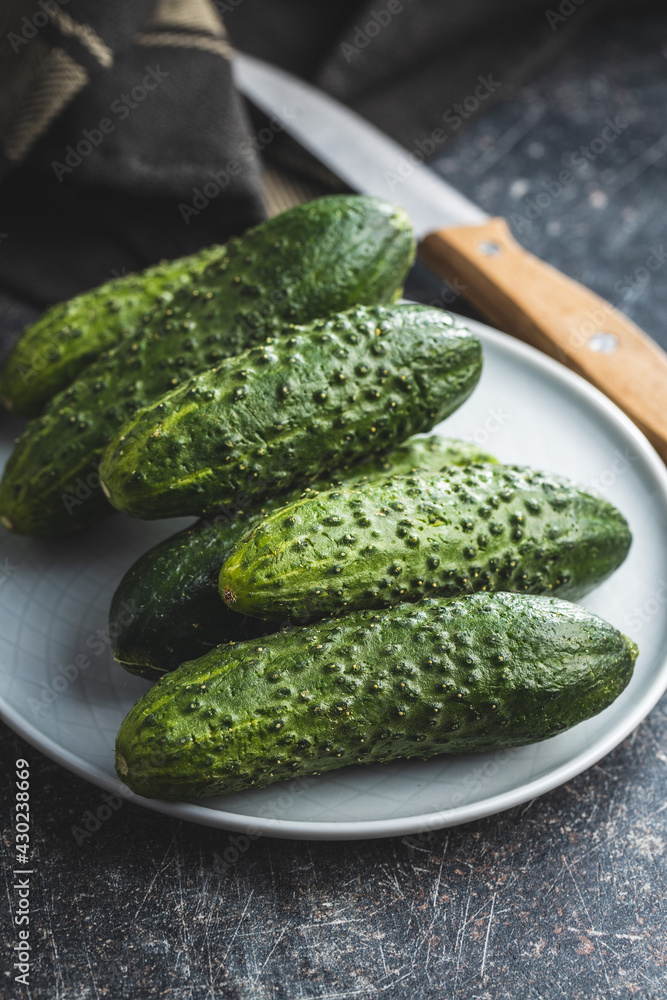 Fresh green cucumbers on black kitchen table. Fresh green cucumbers on black kitchen table.