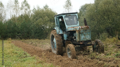 tractor ploughs arable land  an agricultural concept