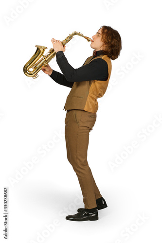 Full length portrait of a young man playing on saxophone isolated on white background