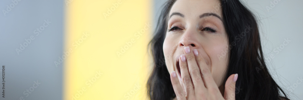 Portrait of young yawning brunette woman at home Portrait of young yawning brunette woman at home
