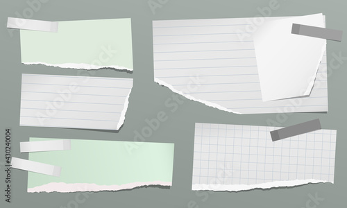 Set of torn green, white note, notebook paper pieces with sticky tape stuck on dark grey background. Vector illustration