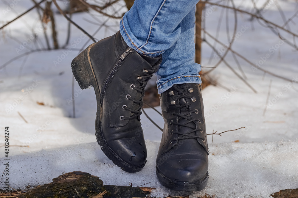 Woman winter boots on snow.