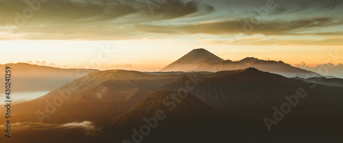 Beautiful landscape of  magical clouds abov mountains in beams of sunlight photo