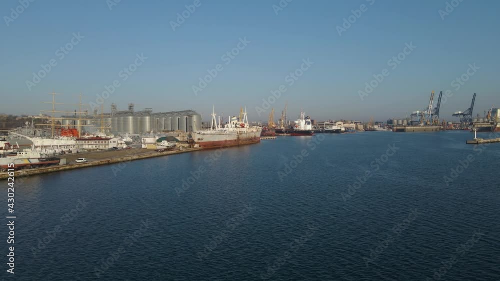 Aerial view of a cargo ship in the port dock Trade Export. Loading and unloading in deep water port, Aerial view of business logistics import and export cargo transportation Aerial view of a cargo ship in the port dock Trade Export. Loading and unloading in deep water port, Aerial view of business logistics import and export cargo transportation