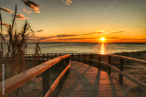 Wooden walkway to the beach at sunrise in Alicante, Spain