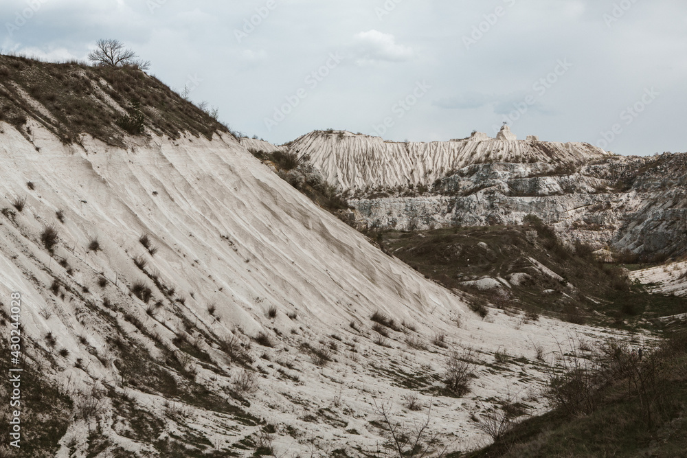 Abandoned limestone quarry. Interesting form of relief. Amazing hills and ground. Dry areas of the earth. Global warming