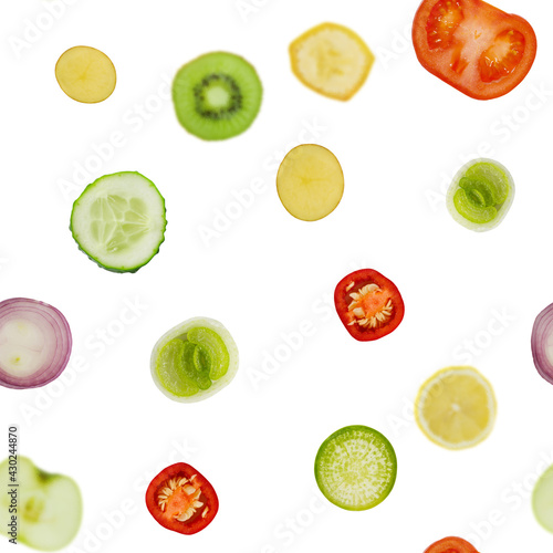 Seamless texture of vegetables, cucumber, tomato, onion, potato and pepper. On the background, the fruit is in soft focus