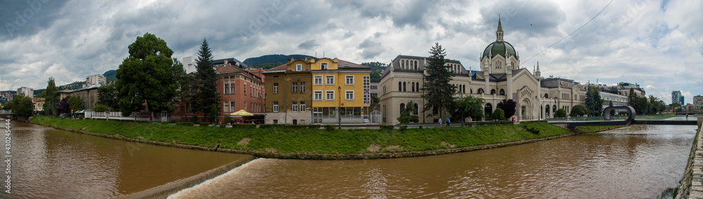 Panoramic view of the river Miljacka, The Academy of Fine Arts is the building in the background and the Festina Lente bridge on the right side. Sarajevo. Bosnia and Herzegovina. 07-08-2018