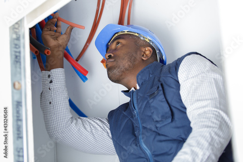 the electrician is fixing an electric corrugated tube