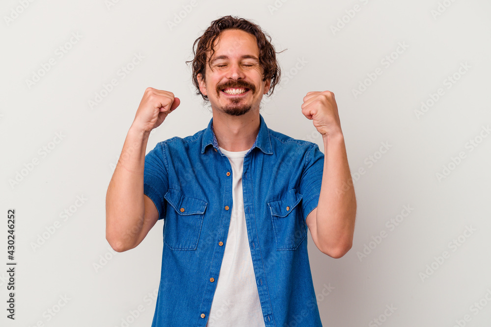 Young caucasian man isolated on white background celebrating a victory, passion and enthusiasm, happy expression. Young caucasian man isolated on white background celebrating a victory, passion and enthusiasm, happy expression.