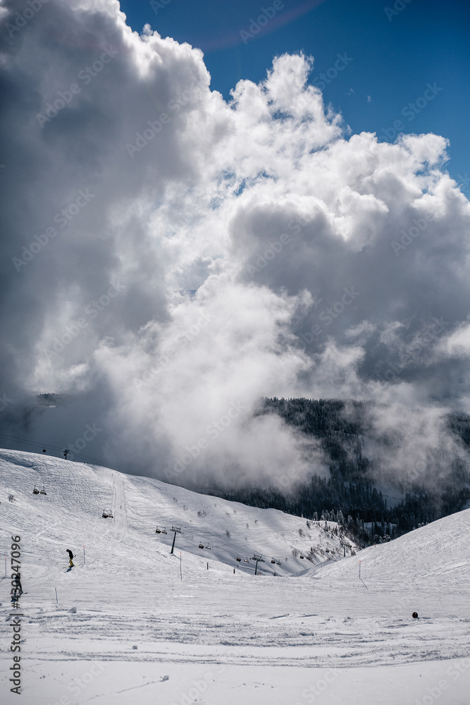 Winter mountain landscape and cloudy sky of Krasnaya Polyana, Sochi, Russia