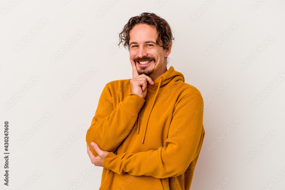 Fototapeta premium Young caucasian man isolated on white background smiling happy and confident, touching chin with hand.