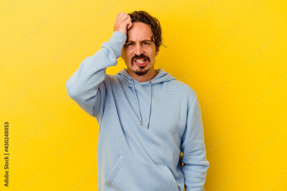 Young caucasian man isolated on yellow background forgetting something, slapping forehead with palm and closing eyes. Young caucasian man isolated on yellow background forgetting something, slapping forehead with palm and closing eyes.