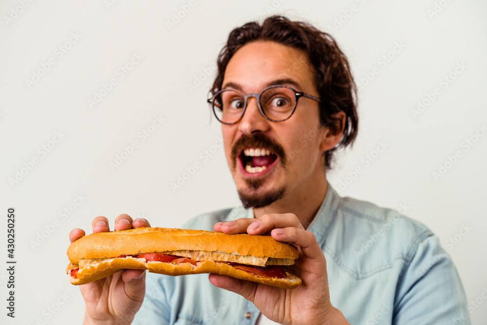 Young caucasian man holding a sandwich isolated on white background Young caucasian man holding a sandwich isolated on white background