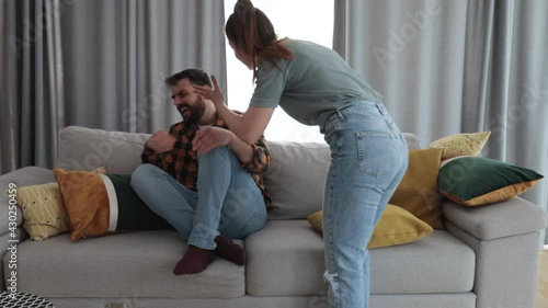 Newly married young couple where a woman attacks and mentally abuses her young husband due to sick jealousy and possessiveness and he suffers from domestic violence trying to defend himself  photo