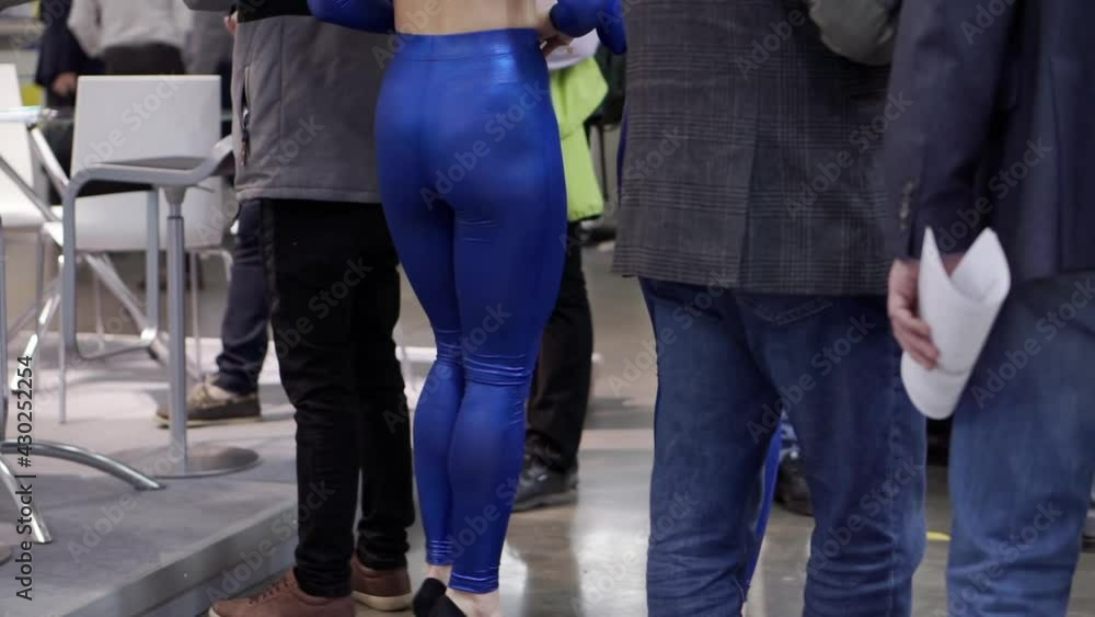 Two girls with a beautiful figure are walking in the business center. Two girls with a beautiful figure are walking in the business center.