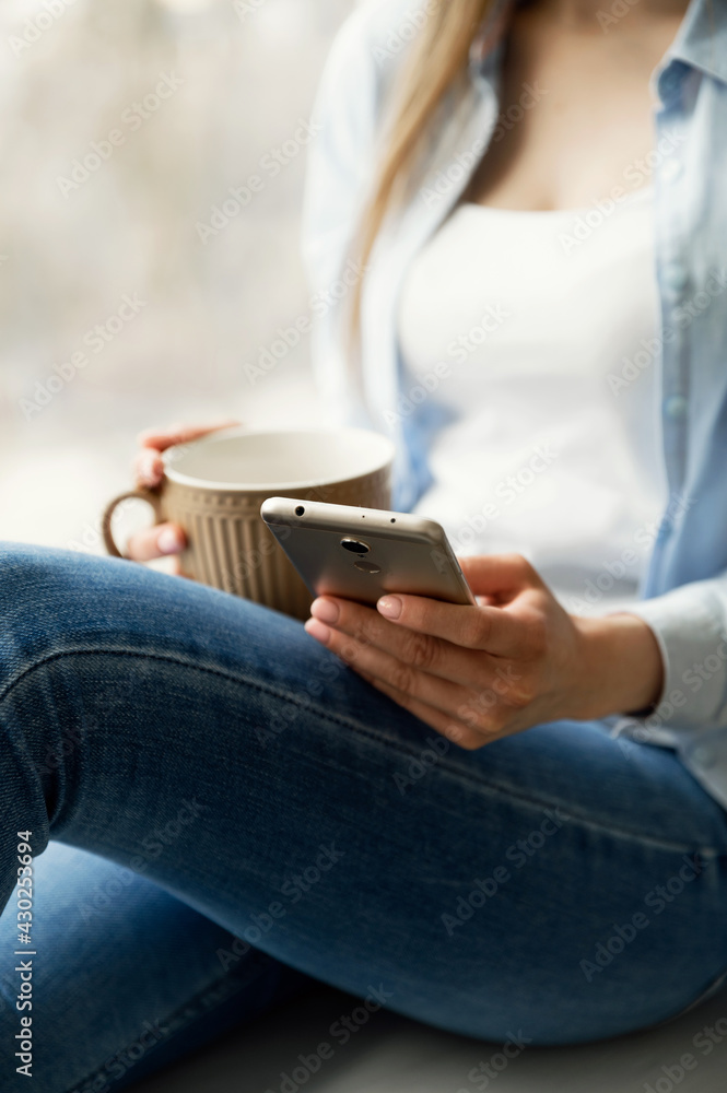 phone in the hands of a girl close-up. girl uses a smartphone. device in hand. the student is using the phone. phone in the hands of a girl close-up. girl uses a smartphone. device in hand. the student is using the phone.