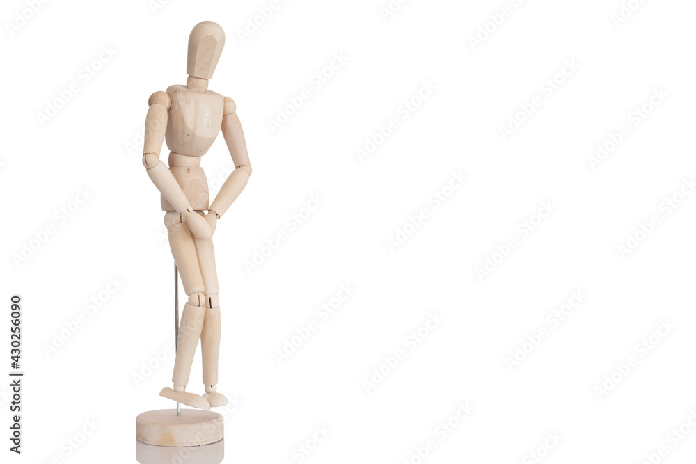 Wooden man in a position of pain or discomfort in the intimate parts. Representation of the discomfort of the urinary system. Concept of urinary incontinence or urinary tract infections. Wooden man in a position of pain or discomfort in the intimate parts. Representation of the discomfort of the urinary system. Concept of urinary incontinence or urinary tract infections.