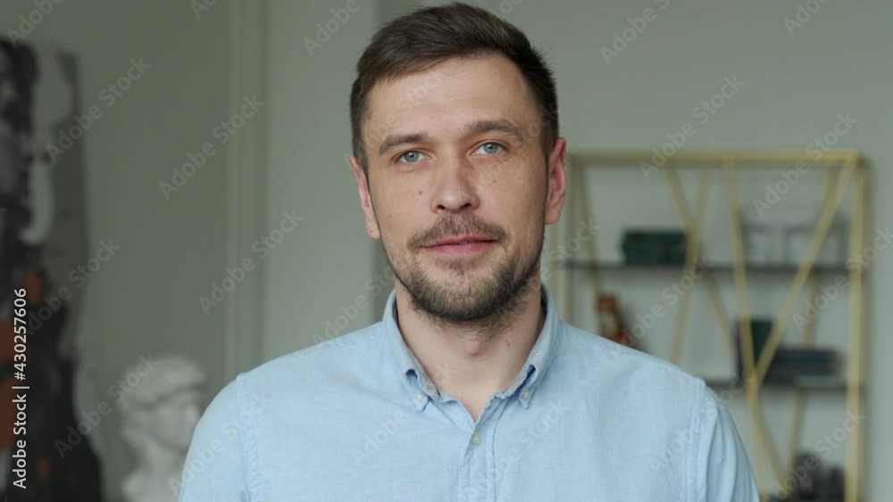 Portrait of a young handsome man in a shirt smiling at the camera Portrait of a young handsome man in a shirt smiling at the camera