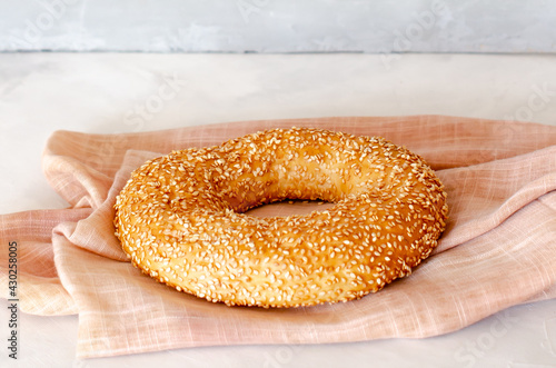 Simit Turkish crispy braided bagel with sesame seeds. Turkish homemade traditional pastries. Side view. Close-up. Copy space