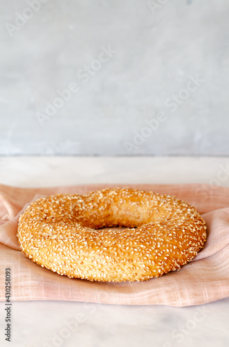 Simit Turkish crispy braided bagel with sesame seeds. Turkish homemade traditional pastries. Side view. Close-up. Copy space