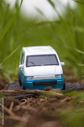 model toy of van on the ground under grass in close up view