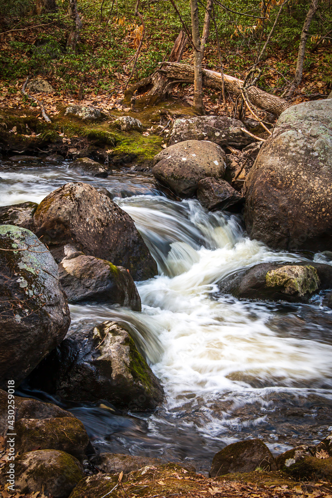 Water flowing over rocks in a stream Water flowing over rocks in a stream