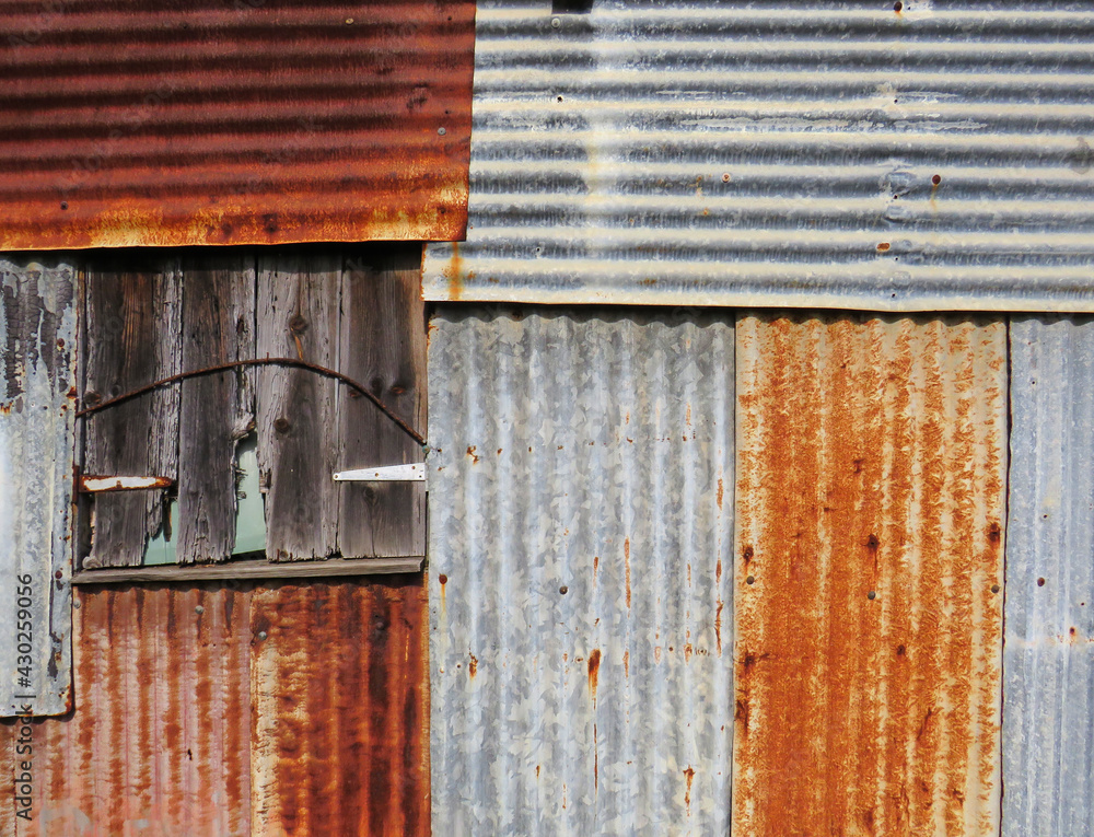 Old and rusty sheet metal facade background in the French West Indies. Sheet metal wall construction. Architecture concept.