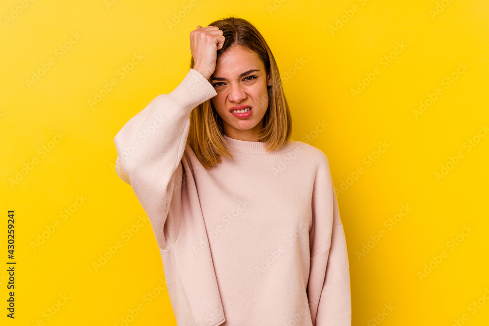 Young caucasian skinny woman isolated on yellow background forgetting something, slapping forehead with palm and closing eyes. Young caucasian skinny woman isolated on yellow background forgetting something, slapping forehead with palm and closing eyes.