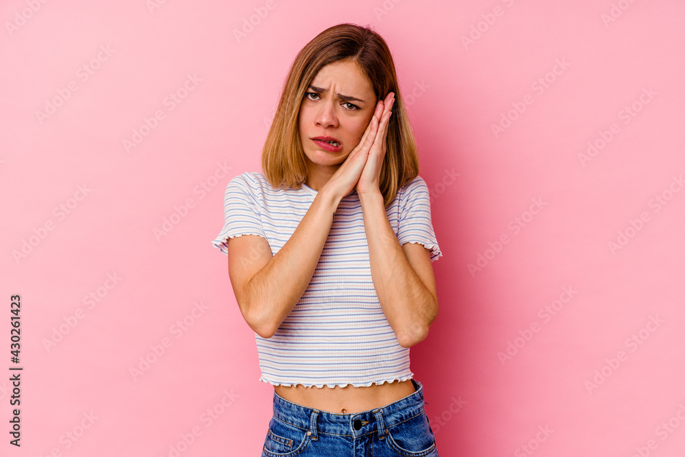 Young caucasian woman isolated on pink background yawning showing a tired gesture covering mouth with hand. Young caucasian woman isolated on pink background yawning showing a tired gesture covering mouth with hand.