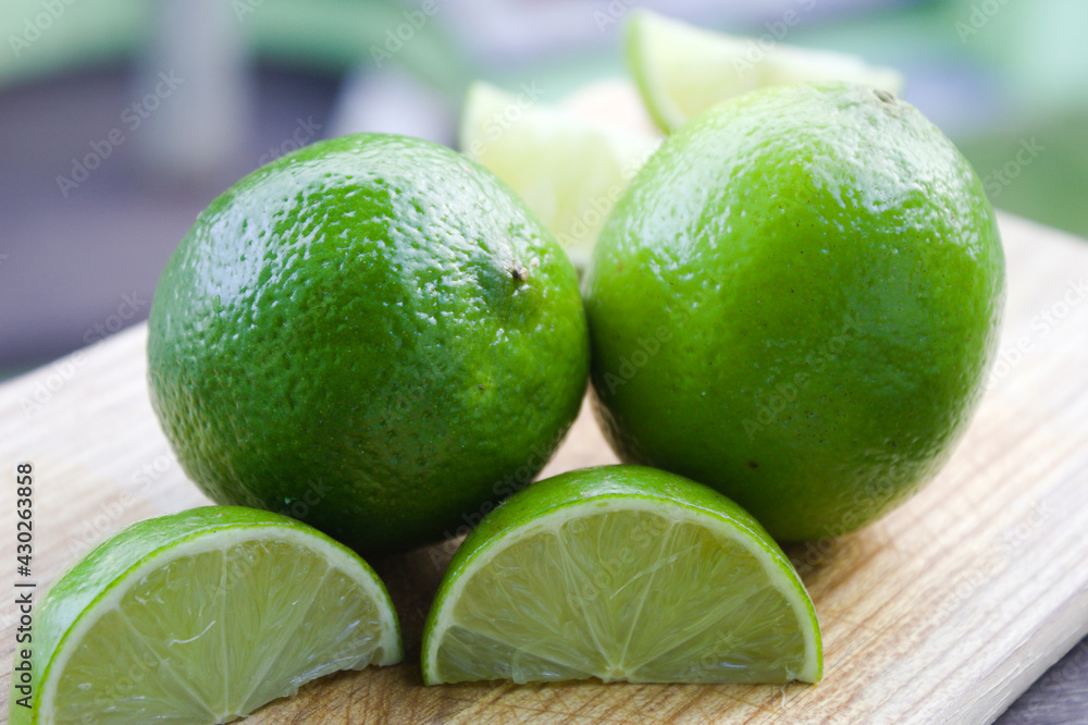 Whole lemon with some slices on a wooden board Whole lemon with some slices on a wooden board