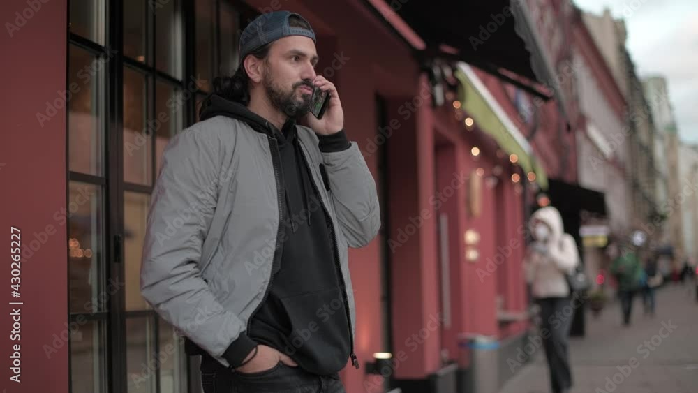 Young, modern handsome man talking on the phone of sunny spring day. Young, modern handsome man talking on the phone of sunny spring day.
