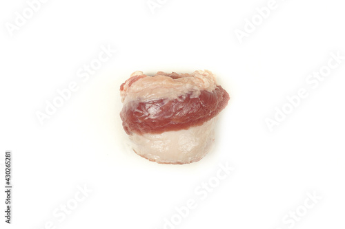 Roll the raw bacon into a tube. Raw meat with lard. Isolated