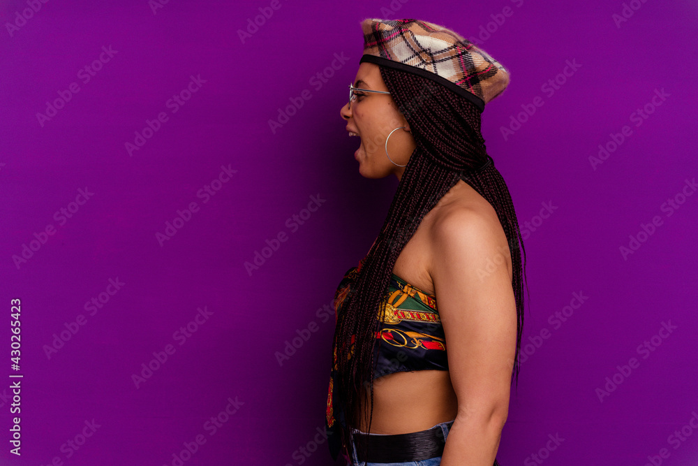 Young african american woman isolated on yellow background Young african american woman isolated on yellow background shouting towards a copy space