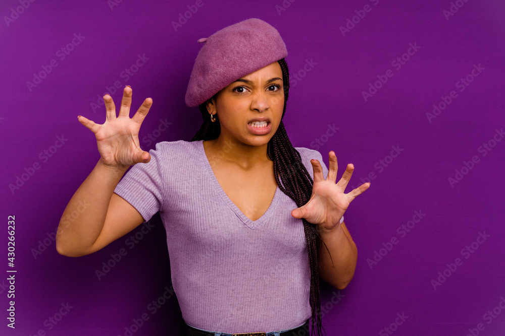 Young african american woman isolated on yellow background Young african american woman isolated on yellow background showing claws imitating a cat, aggressive gesture. Young african american woman isolated on yellow background Young african american woman isolated on yellow background showing claws imitating a cat, aggressive gesture.