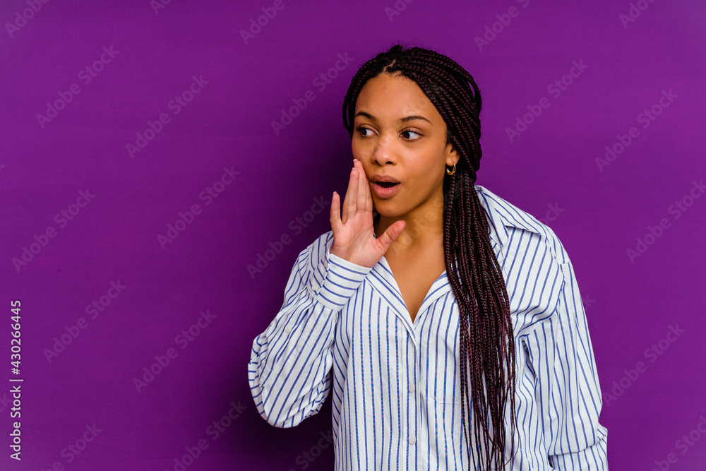 Young african american woman isolated on yellow background Young african american woman isolated on yellow background is saying a secret hot braking news and looking aside Young african american woman isolated on yellow background Young african american woman isolated on yellow background is saying a secret hot braking news and looking aside