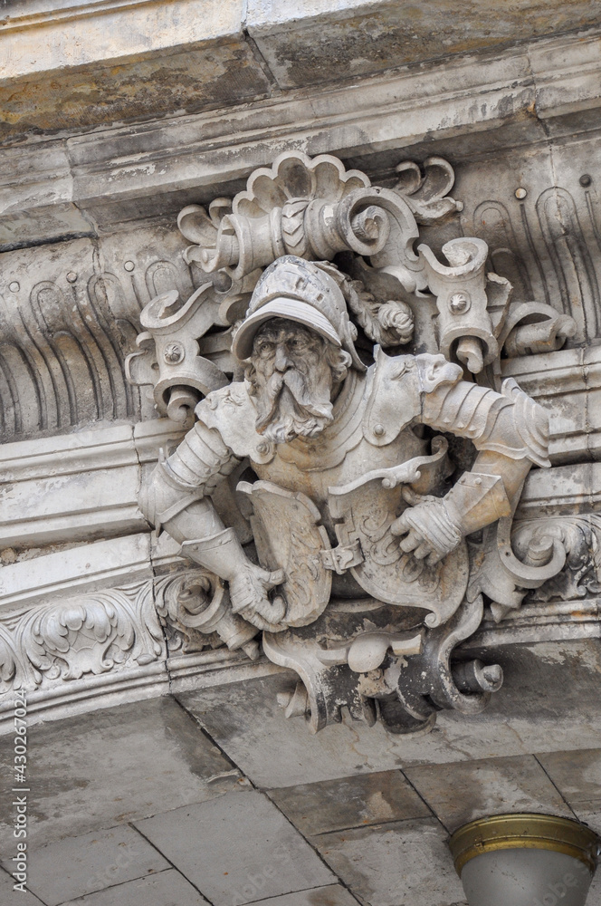 Decorative gatekeeper sculpture on archway of Dresden's royal palace.