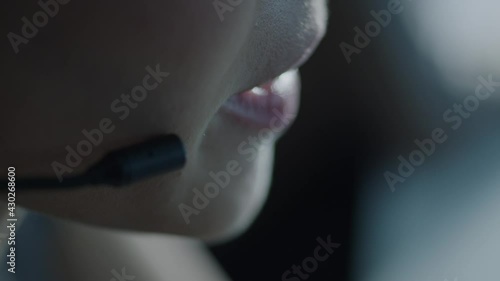 Close up of woman in glasses wearing headset with microphone and talking  Slow motion video. 