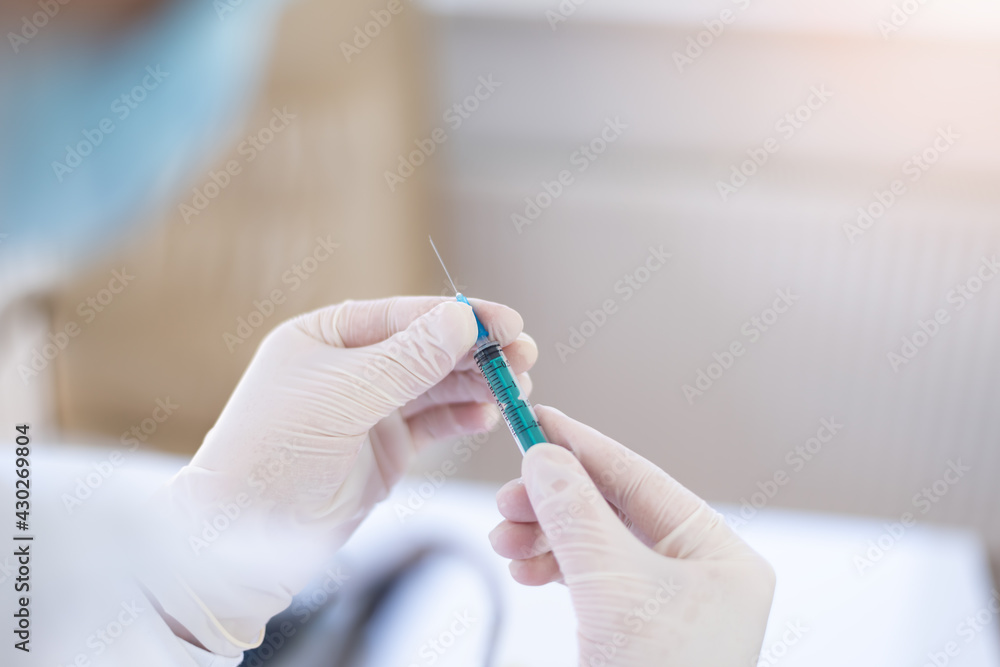Female Doctor preparing the coronavirus COVID-19 vaccine Female Doctor preparing the coronavirus COVID-19 vaccine