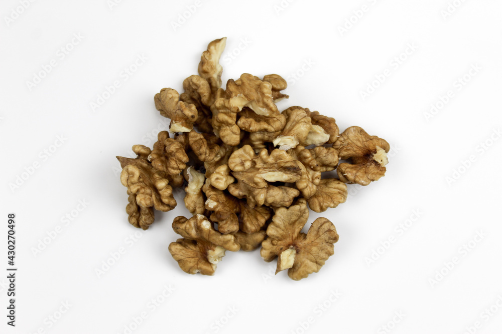 Walnuts, a bunch of peeled walnuts on a white background. Walnut kernels isolated on a white background. Pieces of pulp of walnuts.