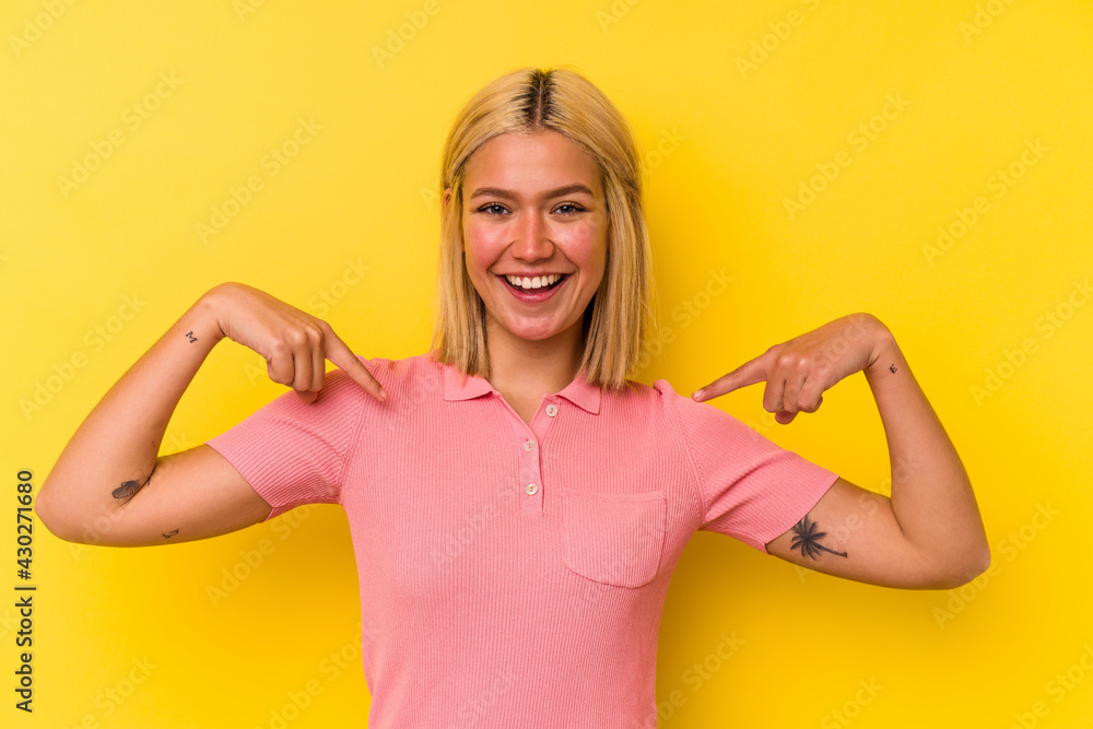 Young venezuelan woman isolated on yellow background surprised pointing with finger, smiling broadly. Young venezuelan woman isolated on yellow background surprised pointing with finger, smiling broadly.