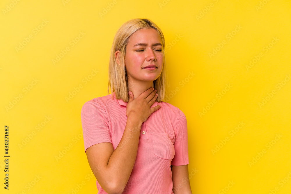 Young venezuelan woman isolated on yellow background suffers pain in throat due a virus or infection. Young venezuelan woman isolated on yellow background suffers pain in throat due a virus or infection.