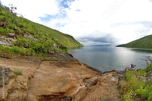 Boat landing in Tagus Cove, Isabela Island, Galapagos, Ecuador, with a Galapagos cruise ship in the distance