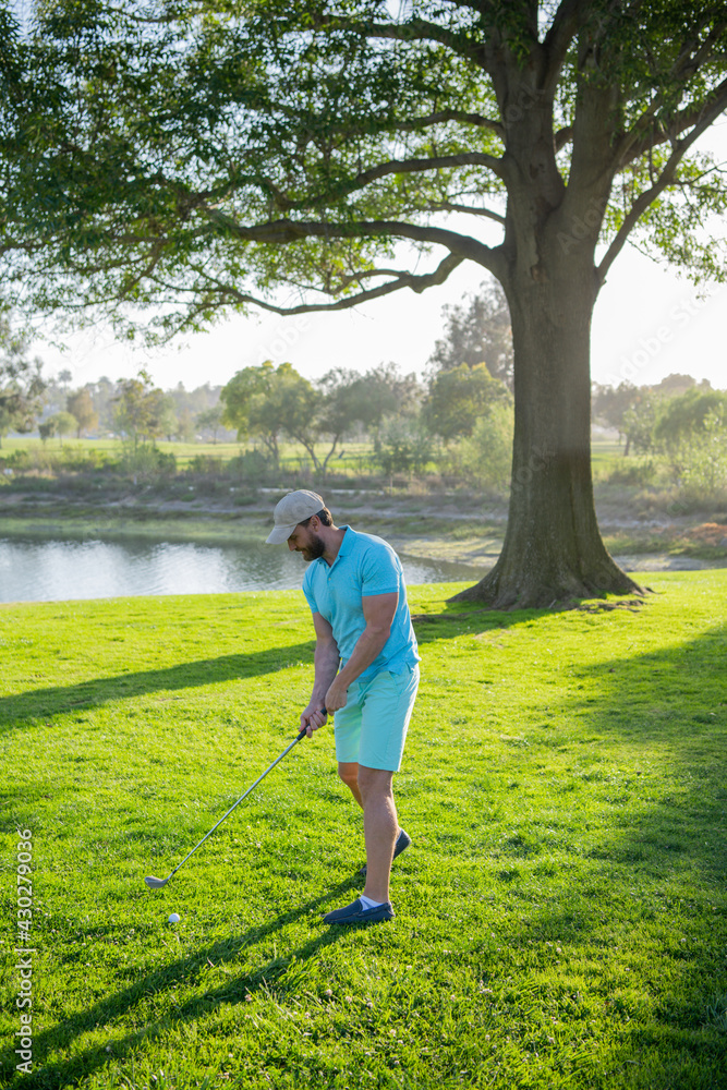 Golf player playing golf on sunny day. Golfer taking shot on golf course. Golf player playing golf on sunny day. Golfer taking shot on golf course.