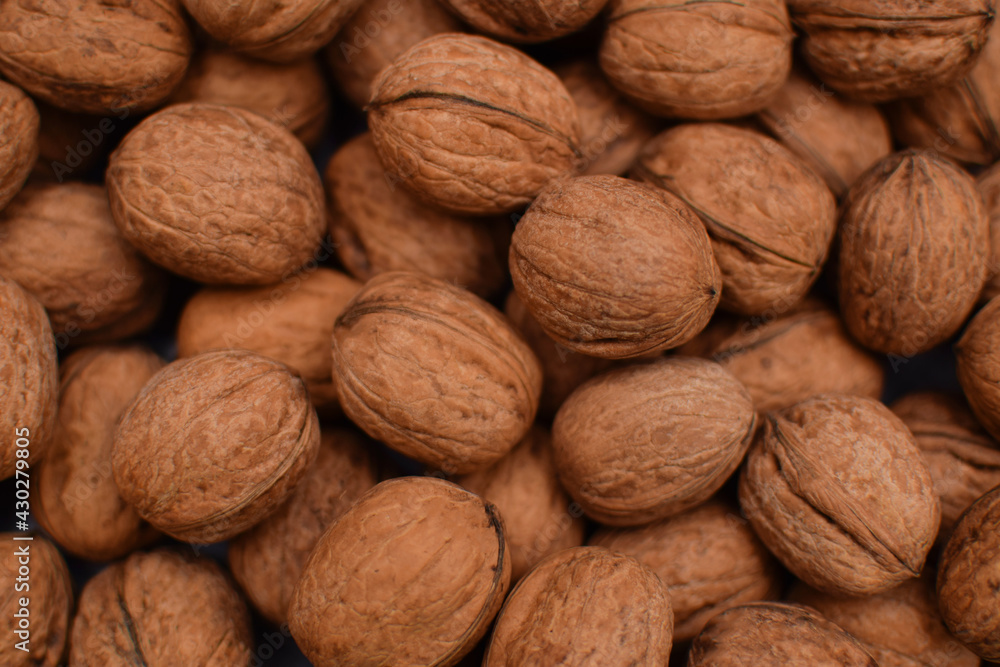 Whole walnuts and nutcracker background. Close up, top view. Harvest concept Whole walnuts and nutcracker background. Close up, top view. Harvest concept