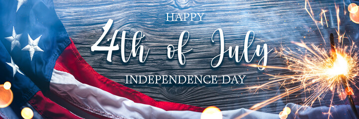  American Flag With Sparkler And Smoke On Wooden Background With Words "Happy 4th Of July Independence Day"