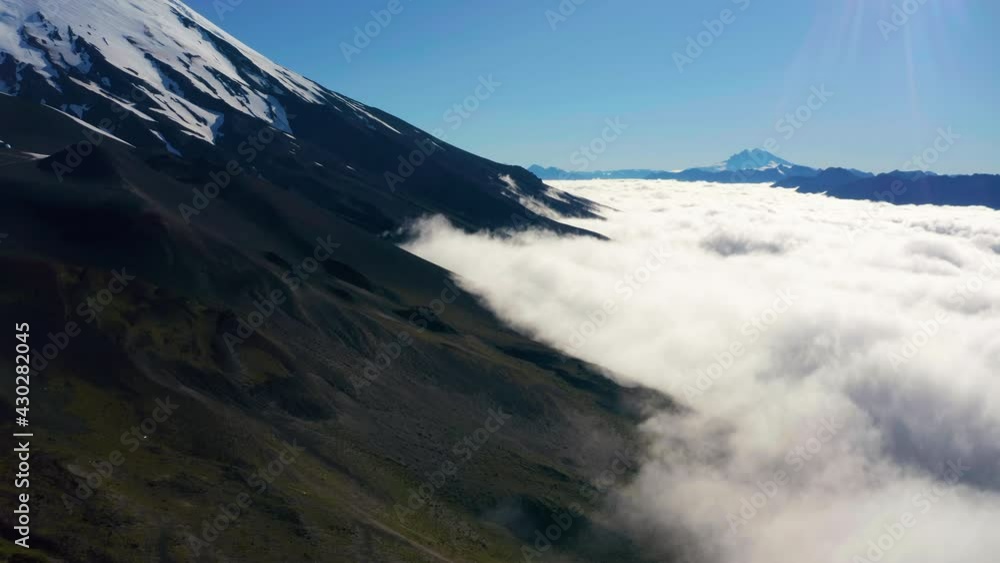 Aerial truck shot showing the mountain ranges of National Park Vicente Perez Rosales in Chile, low lying clouds. Aerial truck shot showing the mountain ranges of National Park Vicente Perez Rosales in Chile, low lying clouds.