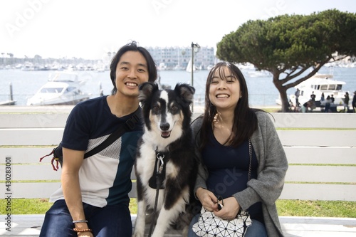Pregnant happy Japanese woman and her husband and dog